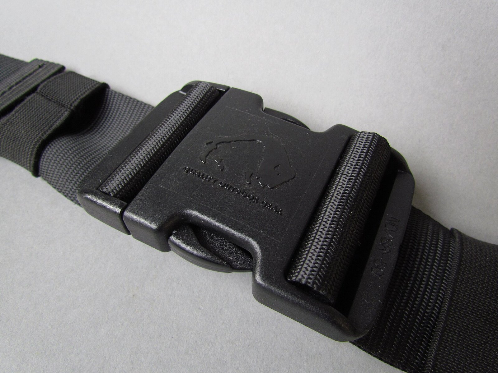 Plastic side release buckle attached to webbing