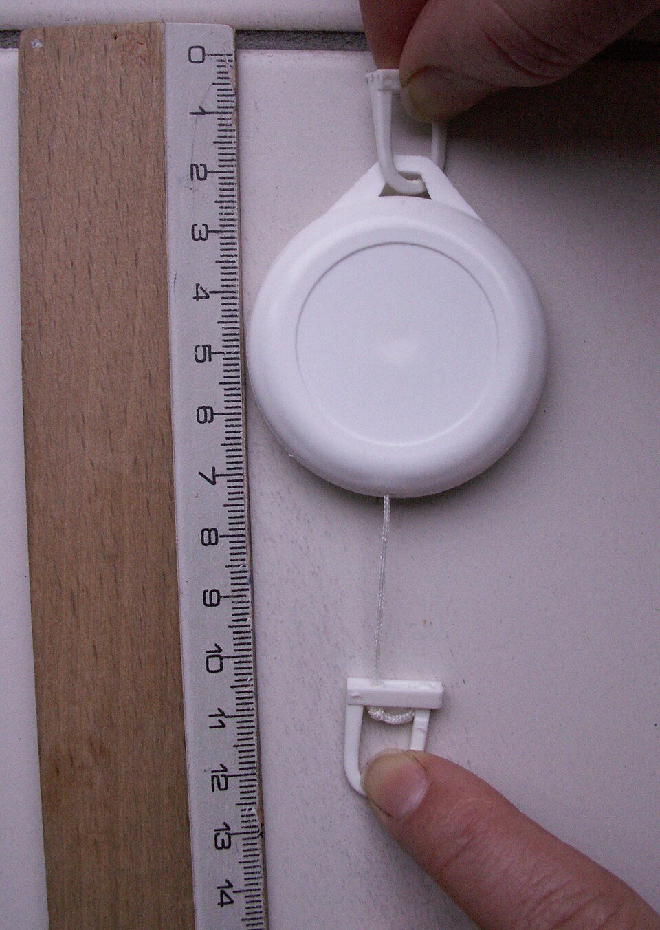 Retractable badge reel with extended cord